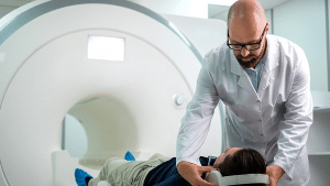 MRI Technologist Putting Headphones On Patient Before MRI Scan