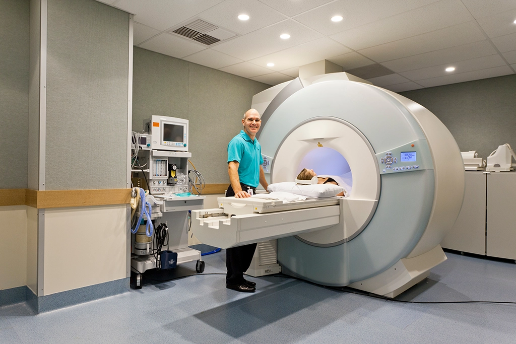 MRI Technologist Smiling While Patient Undergoes An MRI