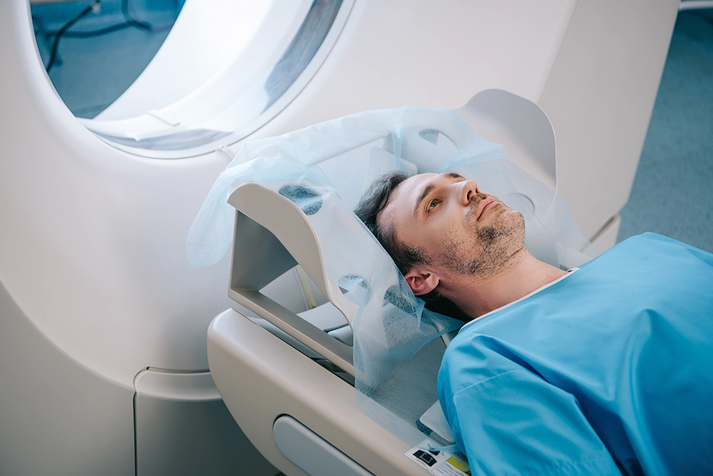 Male Patient Resting Head On CT Scan Table